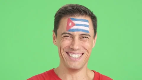Man with a cuban flag painted on the face smiling Stock Footage 253101901