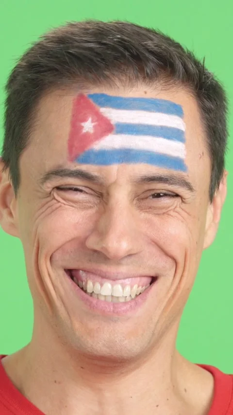 Man with a cuban flag painted on the face smiling Stock Footage 261391674