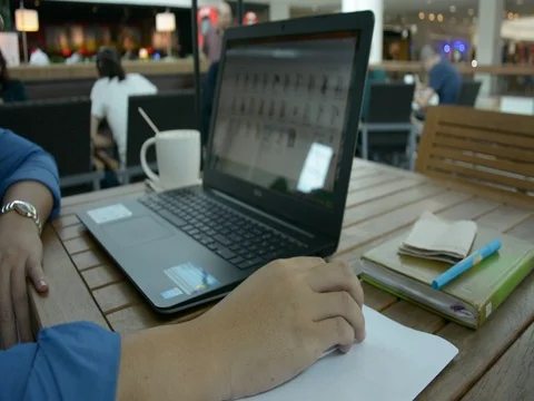 Man with a cup of coffee working on his laptop Stock Footage 83783479