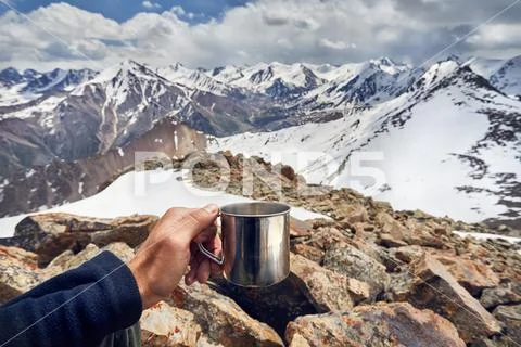 Man with cup in the mountains Stock Photos