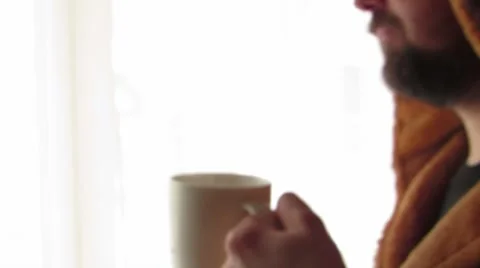 A man with a cup near the window Stock Footage 60128431