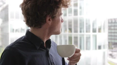 Man with cup of tea looking out of window Stock Footage 41630466