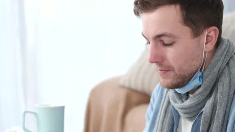 Man curing at home and putting on mask while self-isolation Stock Footage 145763728