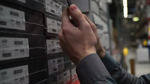 Man customer worker with smartphone choose look for box goods at store warehouse Stock Footage 86889500