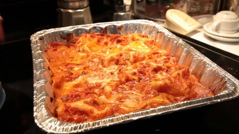Man cut and take a part of lasagna Stock Footage 113056447