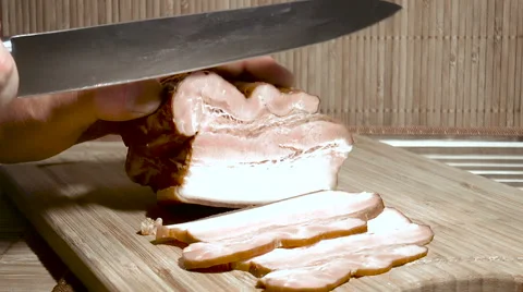 Man cut the bacon into small pieces Stock Footage 68312141