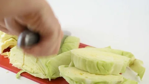 Man cut fresh cabbage with a knife on a cutting board Stock Footage 82614635