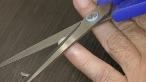 The man cut off his nails with scissors on his hand. Video stock 159055733