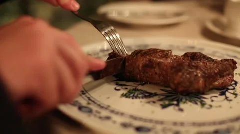 A man cut the meat with a fork and knife close up Stock Footage 61221436