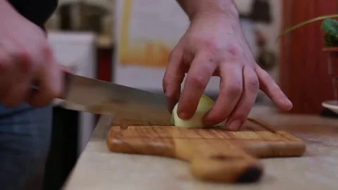 Man Cut The Onions in home kitchen Stock Footage 72961753