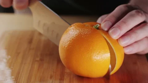 Man cut orange for juice splashes close up Stock Footage 237950725