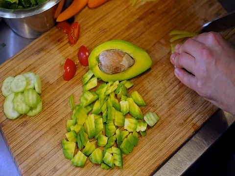 Man cut pepper with avocado Stock Footage 82014403