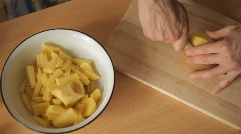 Man cut potatoes in the kitchen Stock Footage 59133769
