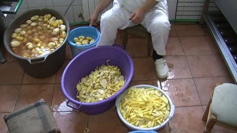 Man cut potatoes in the kitchen Stock Footage 90229576