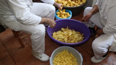 Man cut potatoes in the kitchen Stock Footage 90230967