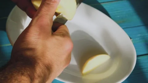 A man cuts an apple into slices Stock-Footage 245647064