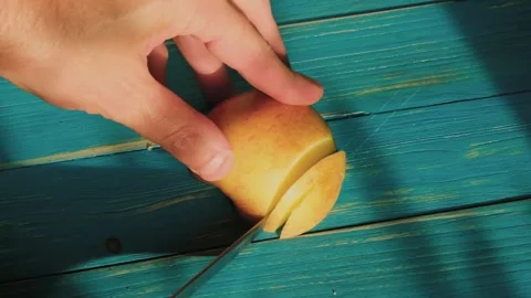 A man cuts an apple into slices Stock Footage 245647065