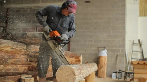Man cuts off beam chainsaw for future home. Man cuts off beam chainsaw for Stock Footage 65205394