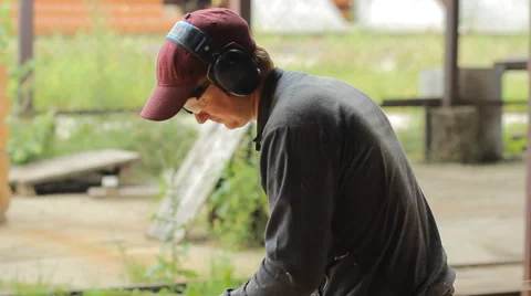 Man cuts off beam chainsaw for future home. Construction works with a wooden Stock Footage 65317595