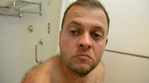 Man cuts a beard in the bathroom Video stock 116908580