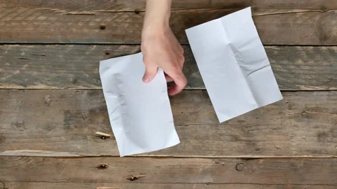 Man cuts a blank white sheet of paper with scissors Stock Footage 134622073
