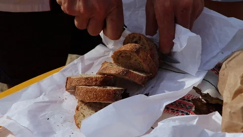 A man cuts bread that he himself baked. Homemade cakes and baked goods. The conc Stock Footage 116617556