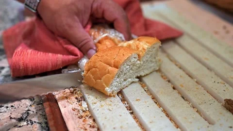 A man cuts bread with a knife Stock Footage 284003563