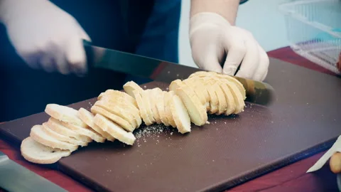 The man cuts the bread for sandwiches Stock Footage 102652143