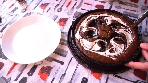 A man cuts a cake and puts it on a plate 스톡 동영상 85672732
