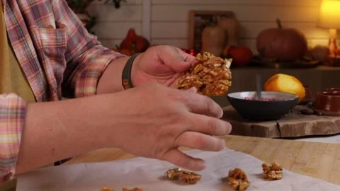 Man cuts caramelized nuts with a knife to decorate pumpkin pie Stock Footage 286116003