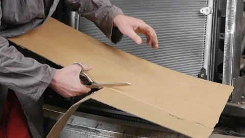 A man cuts the cardboard. Masterwork. Production 動画素材 154555395