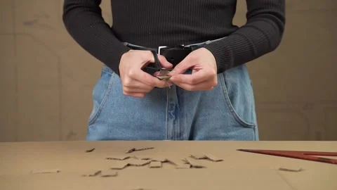 Man cuts cardboard with scissors into small strips. Stock Footage 143235715