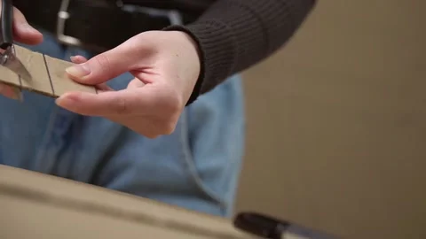 The man cuts the cardboard into strips with scissors Stock Footage 143236190