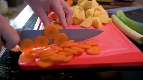 Man cuts carrot into small pieces with a knife 2 Stock Footage 124678616