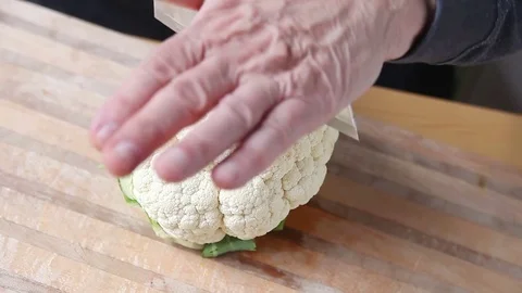 Man cuts cauliflower Stock Footage 75428035