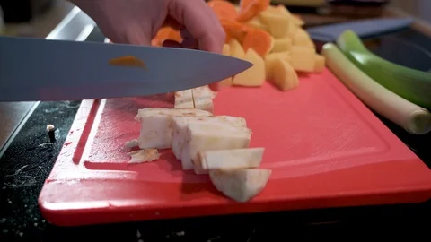 Man cuts celery into small pieces with a knife Stock Footage 124678791