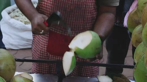 Man cuts coconut to make a drink Stock Footage 59800135