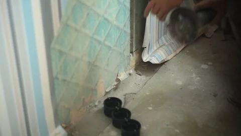 A man cuts a concrete wall using a angle grinder Stock Footage 88613453