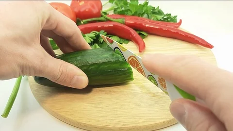 A man cuts a cucumber Stock Footage 125354580