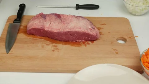 Man cuts fat from a piece of beef with a cook knife - healthy diet food Stock Footage 133714806