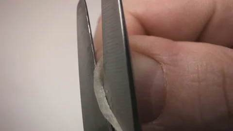 A man cuts a fingernail. Action camera on scissors Stock Footage 146782154