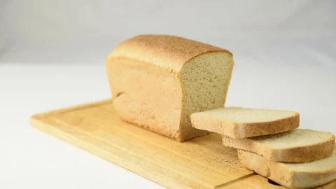 Man cuts fresh crisp bread with a knife Stock Footage 82526723