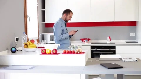 Man cuts fresh spring vegetables on the kitchen table. Stock Footage 116347057