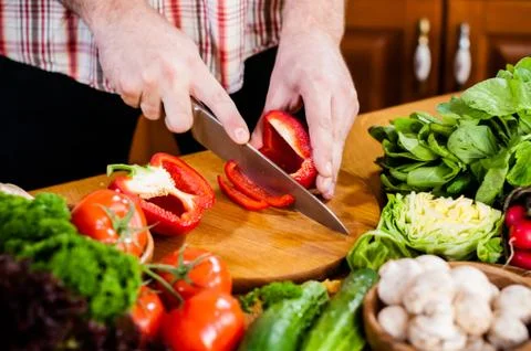 Man cuts fresh spring vegetables Foto stock