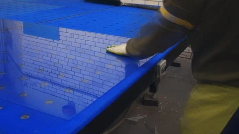 A man cuts the glass on the table.Cutting float glass.Glazier at work. Stock Footage 122291933