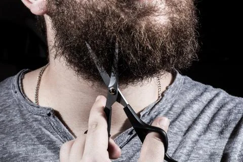 Man cuts his beard Stock Photos