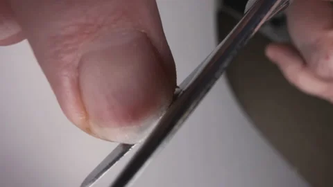 A man cuts his fingernails with scissors. Close-up Stock Footage 146782410
