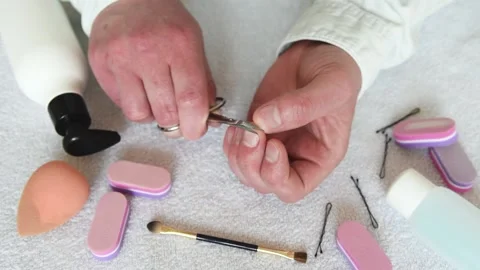 A man cuts his fingernails with small nail scissors. Stock Footage 151579389
