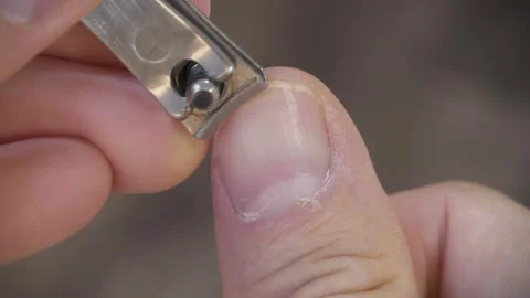 Man cuts his fingernails using a nail clipper Stock Footage 315439472