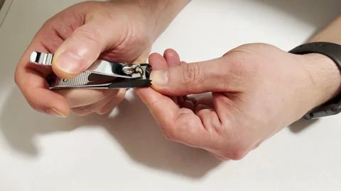 Man cuts his nails. Self-care nails. Stock Footage 169865403
